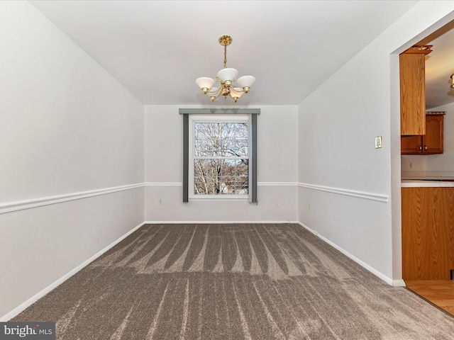 unfurnished dining area featuring a notable chandelier and carpet