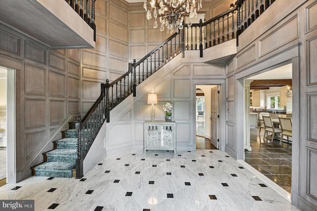 entryway with a chandelier and a high ceiling