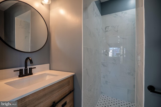 bathroom with vanity and a tile shower