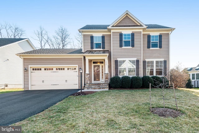 view of front of house with an attached garage, driveway, and a front yard