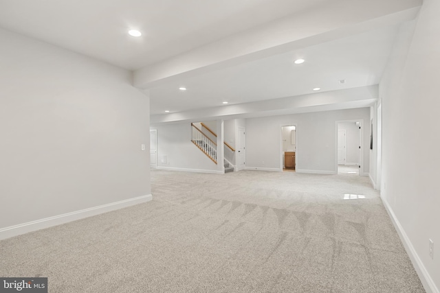 basement with baseboards, stairway, and recessed lighting