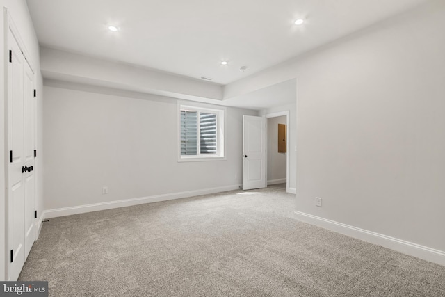 spare room with baseboards, carpet flooring, and recessed lighting