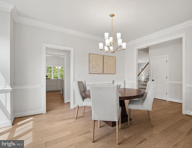 dining space with stairs, light wood-type flooring, crown molding, and an inviting chandelier