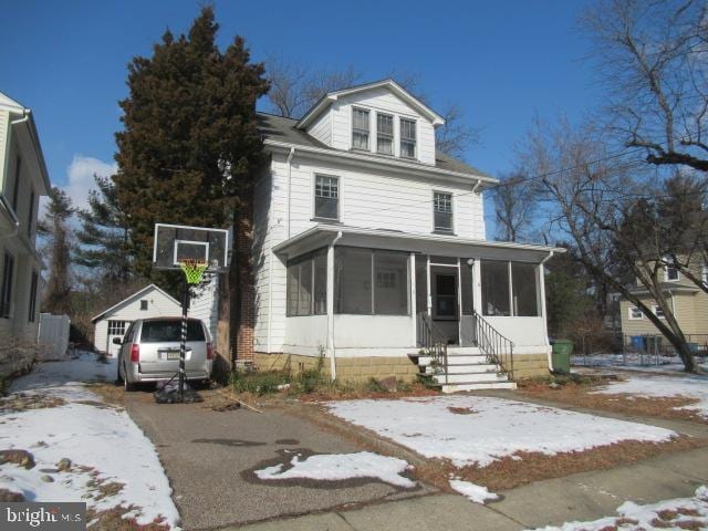 view of front of property with a sunroom