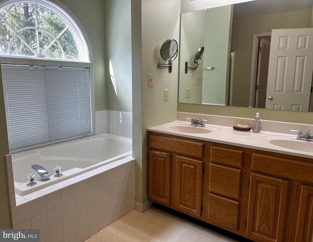 bathroom with vanity and a relaxing tiled tub