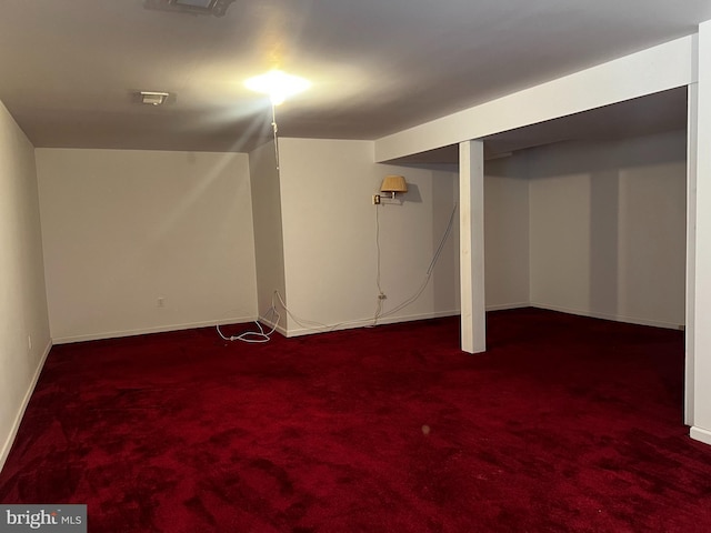 basement featuring dark colored carpet