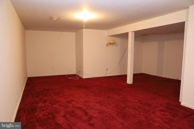 basement featuring dark carpet