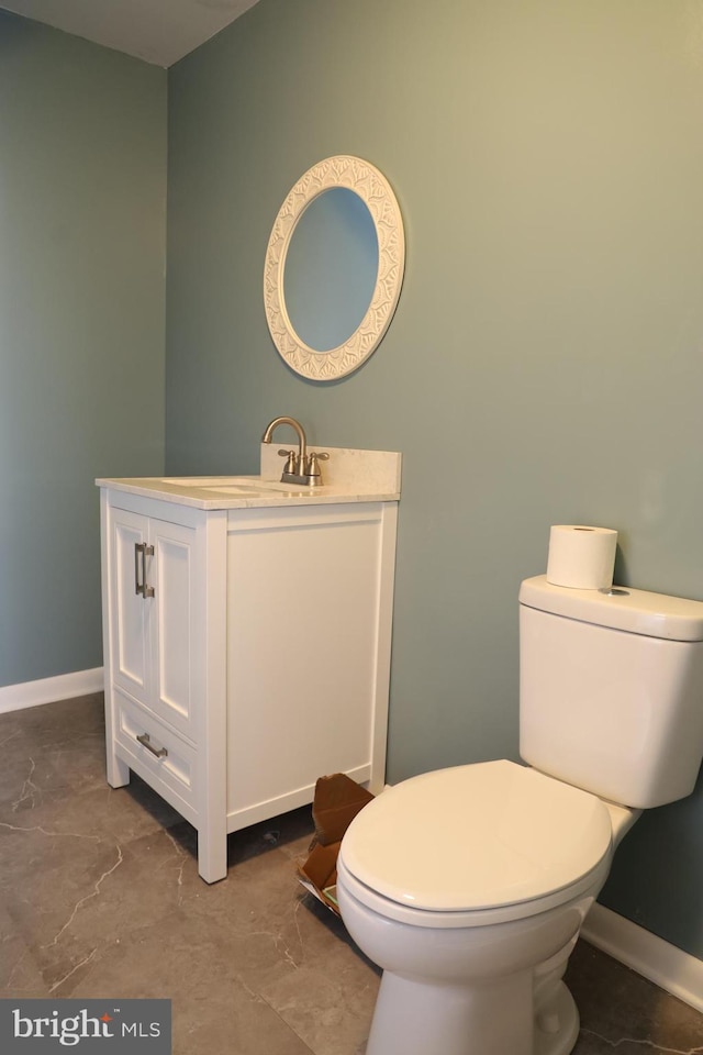 bathroom featuring vanity and toilet