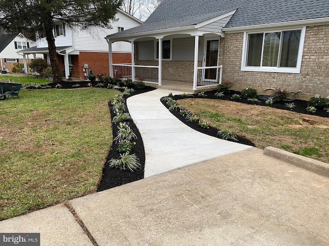 property entrance featuring a porch and a yard