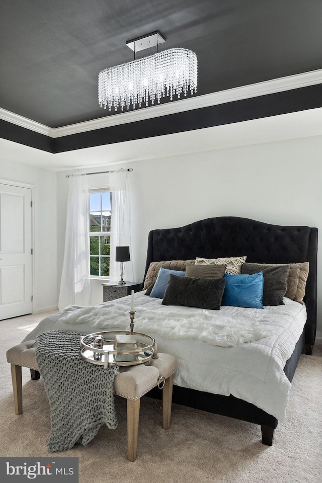 carpeted bedroom featuring crown molding and a raised ceiling