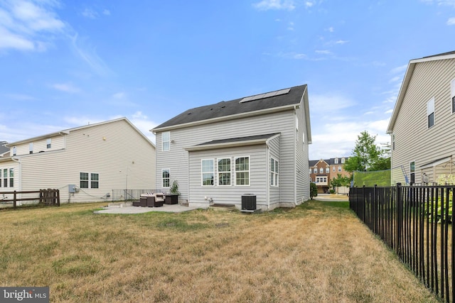 back of house with a lawn, a patio, and central air condition unit