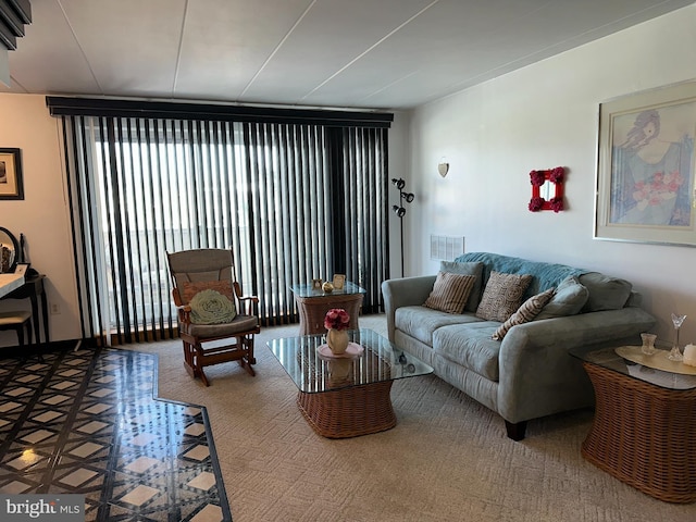 living room with floor to ceiling windows and carpet flooring