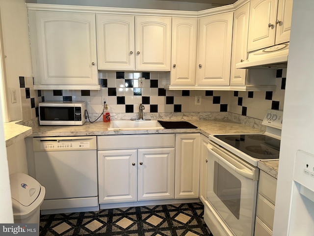 kitchen with white cabinetry, sink, white appliances, and decorative backsplash