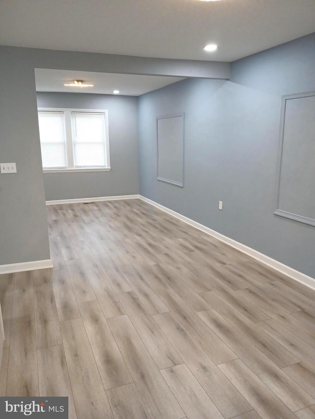 unfurnished room with light wood-type flooring