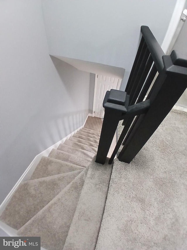 staircase featuring baseboards