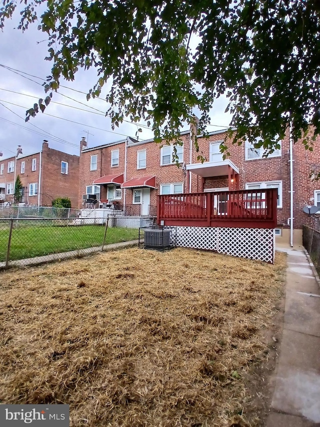 view of yard with a wooden deck and central AC unit