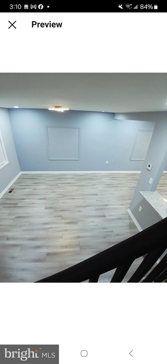 interior space featuring baseboards and wood finished floors