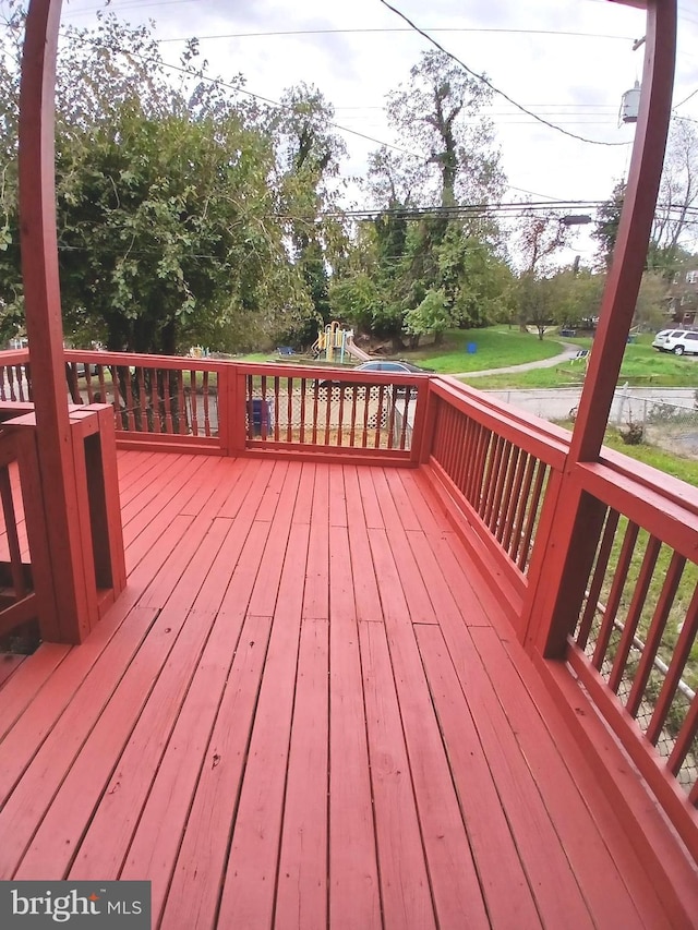 wooden terrace with a playground