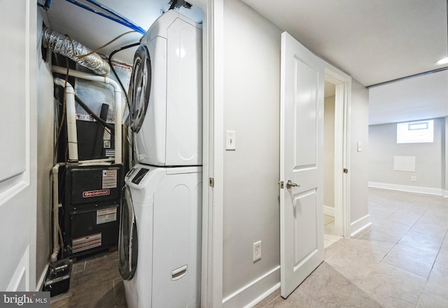 laundry area featuring stacked washing maching and dryer