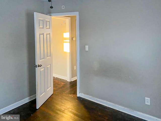 spare room featuring dark wood-type flooring