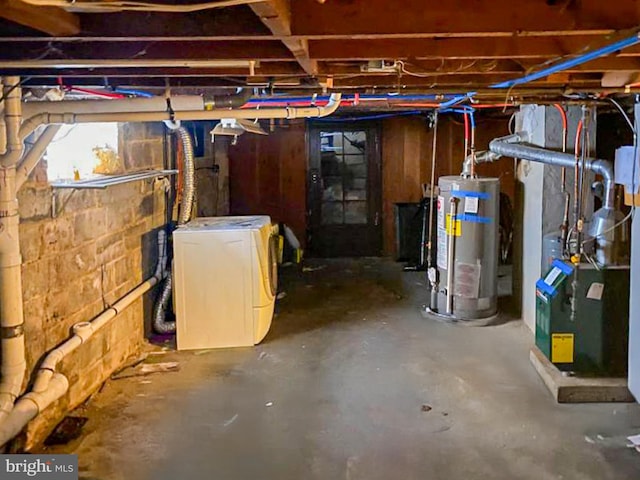 basement with gas water heater and washing machine and clothes dryer