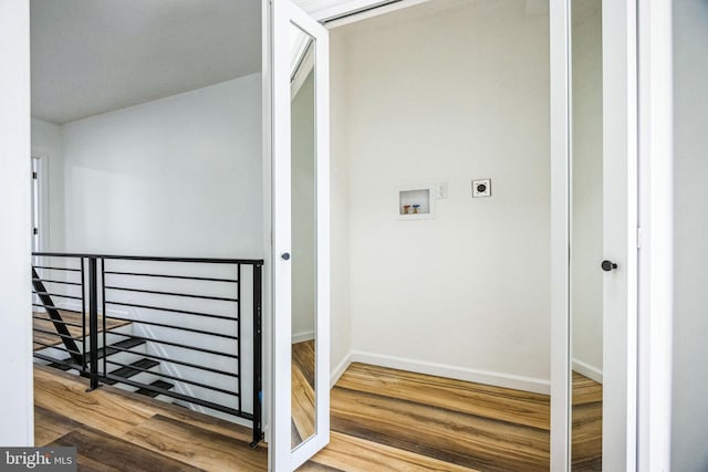 clothes washing area featuring hardwood / wood-style flooring, washer hookup, and hookup for an electric dryer