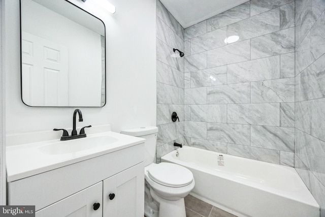 full bathroom featuring tiled shower / bath combo, vanity, tile patterned floors, and toilet