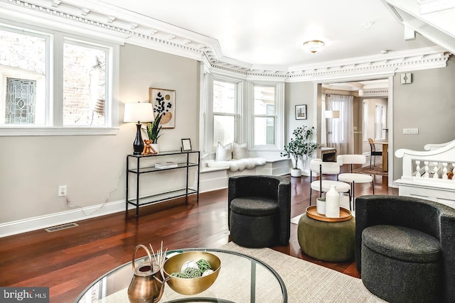 living area with ornamental molding, dark hardwood / wood-style floors, and a wealth of natural light