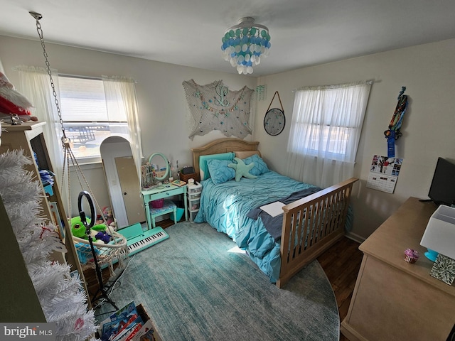 bedroom with dark hardwood / wood-style flooring