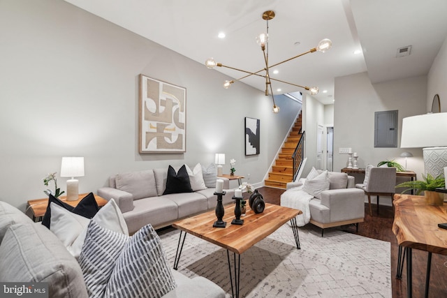 living room with electric panel and light hardwood / wood-style flooring