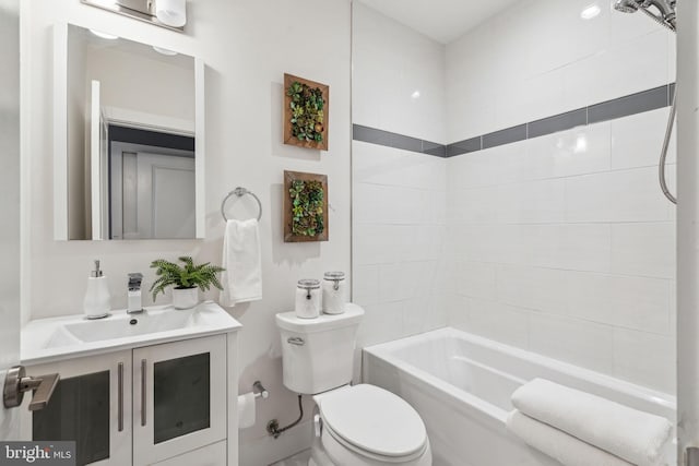 full bathroom with tiled shower / bath combo, vanity, and toilet