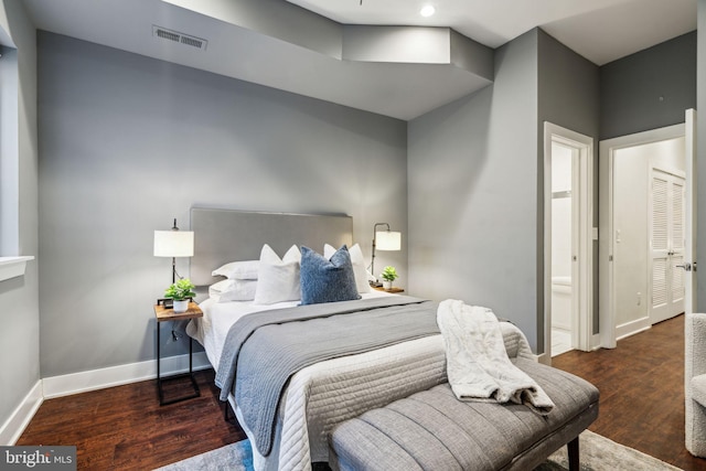 bedroom with dark hardwood / wood-style floors