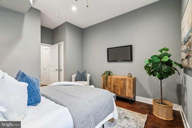 bedroom with dark hardwood / wood-style floors