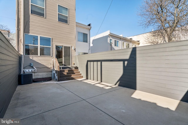 back of house featuring a patio area and central air condition unit