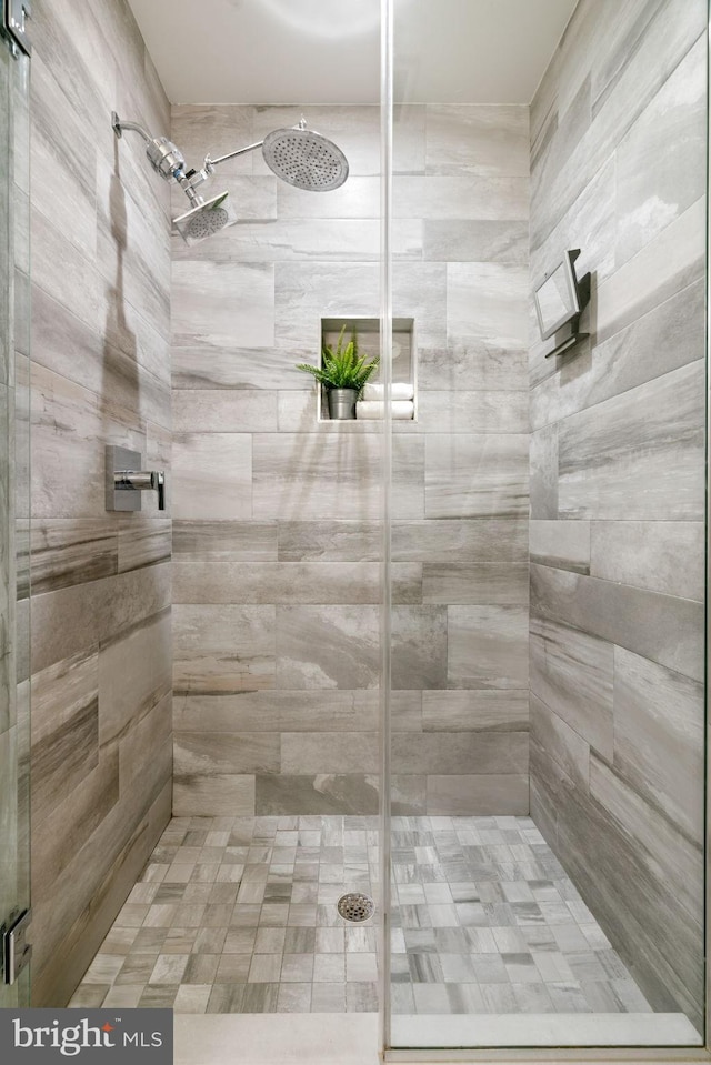 bathroom featuring a shower with door