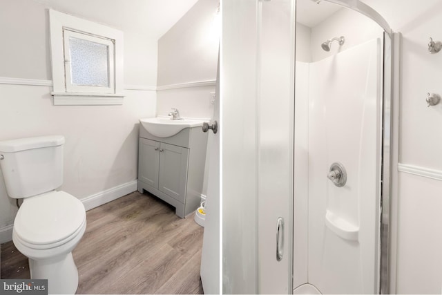 bathroom with vanity, hardwood / wood-style flooring, a shower, and toilet