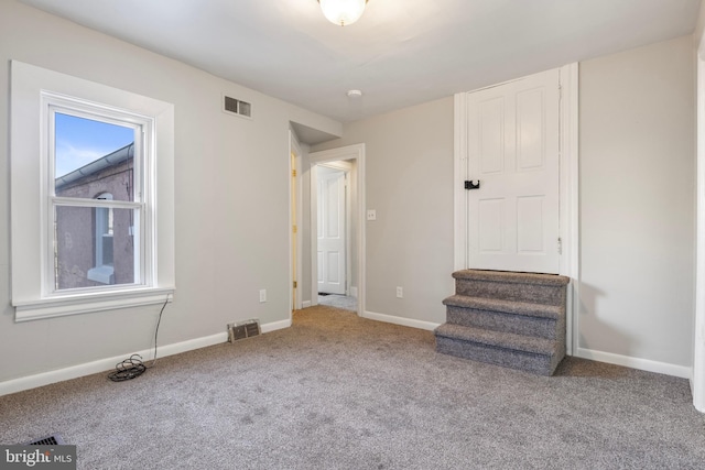 unfurnished bedroom featuring multiple windows and light colored carpet