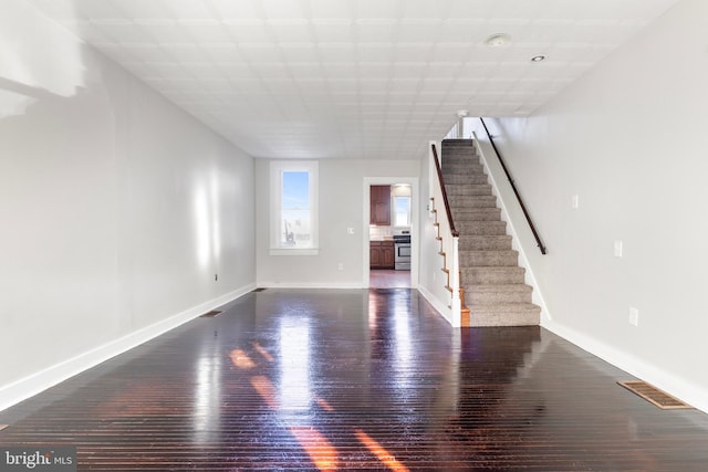 unfurnished living room featuring dark hardwood / wood-style floors