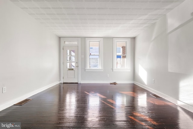 spare room with dark hardwood / wood-style flooring