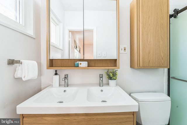 bathroom featuring vanity and toilet