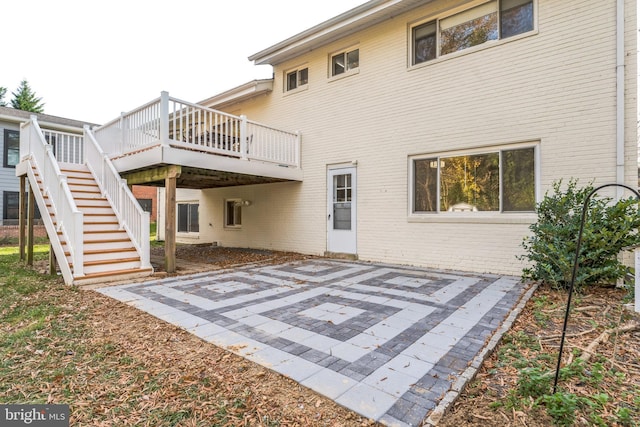 rear view of property featuring a patio and a deck