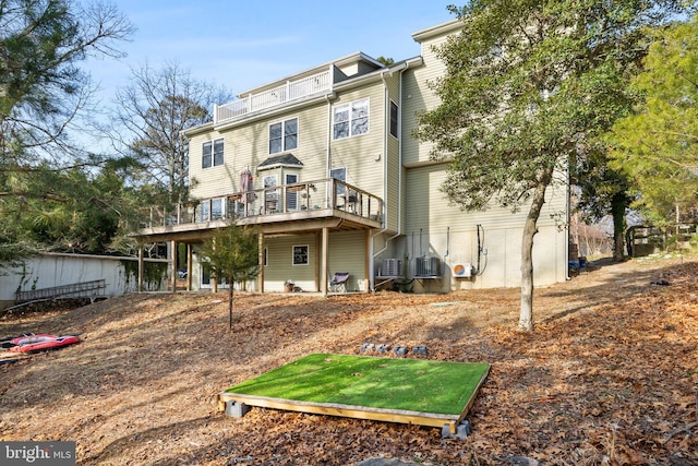 back of property featuring a wooden deck