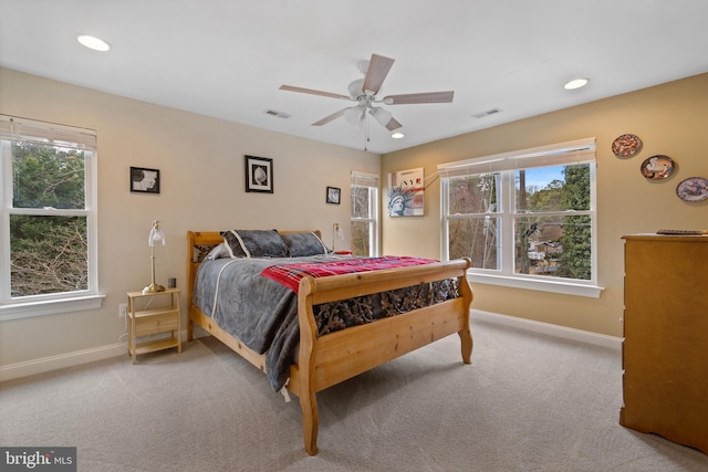 carpeted bedroom featuring a ceiling fan, recessed lighting, visible vents, and baseboards