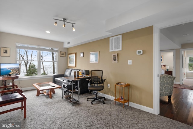 home office with visible vents, baseboards, and wood finished floors