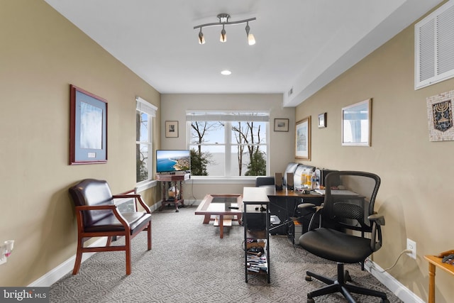 office featuring light carpet, visible vents, and baseboards