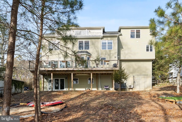 rear view of property featuring a wooden deck