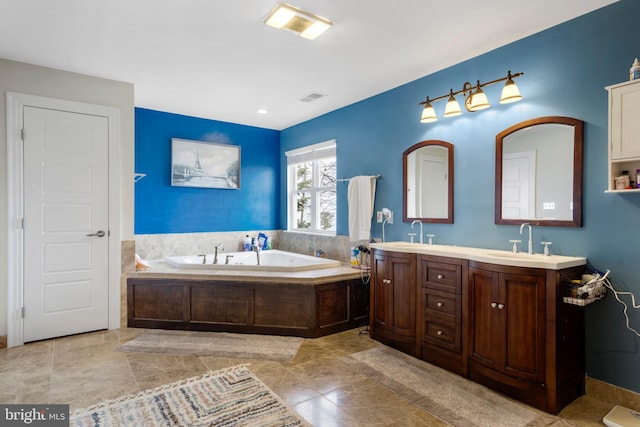 full bathroom with a bath, double vanity, a sink, and visible vents