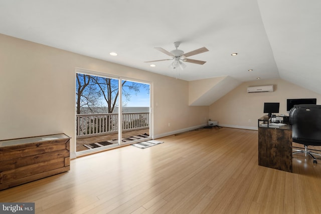 office with lofted ceiling, a ceiling fan, baseboards, an AC wall unit, and light wood finished floors