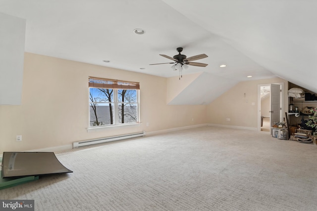 bonus room featuring light carpet, baseboards, a baseboard heating unit, and lofted ceiling