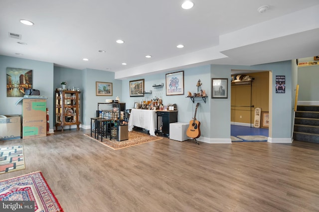 miscellaneous room featuring stairs, wood finished floors, visible vents, and recessed lighting